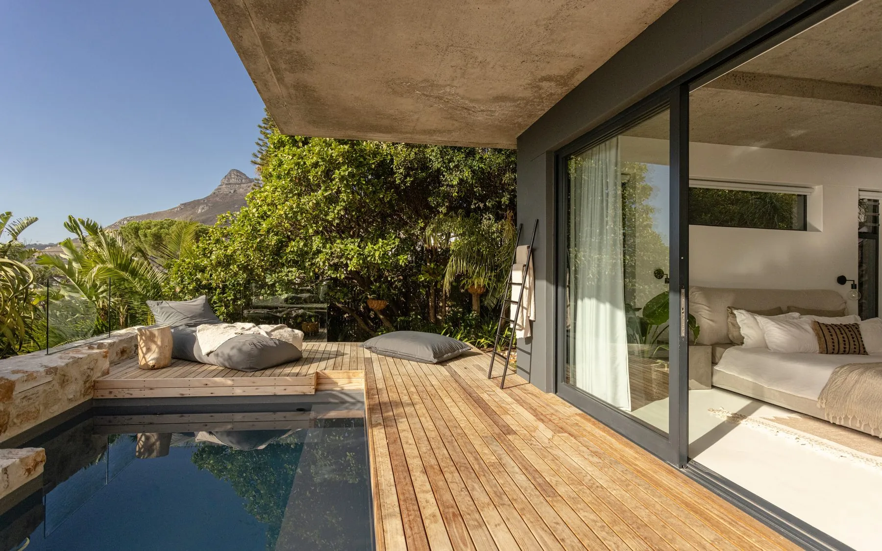 One pool in the shade, one with the bay in front.
